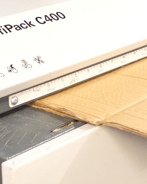 Turning waste cardboard into packaging material
